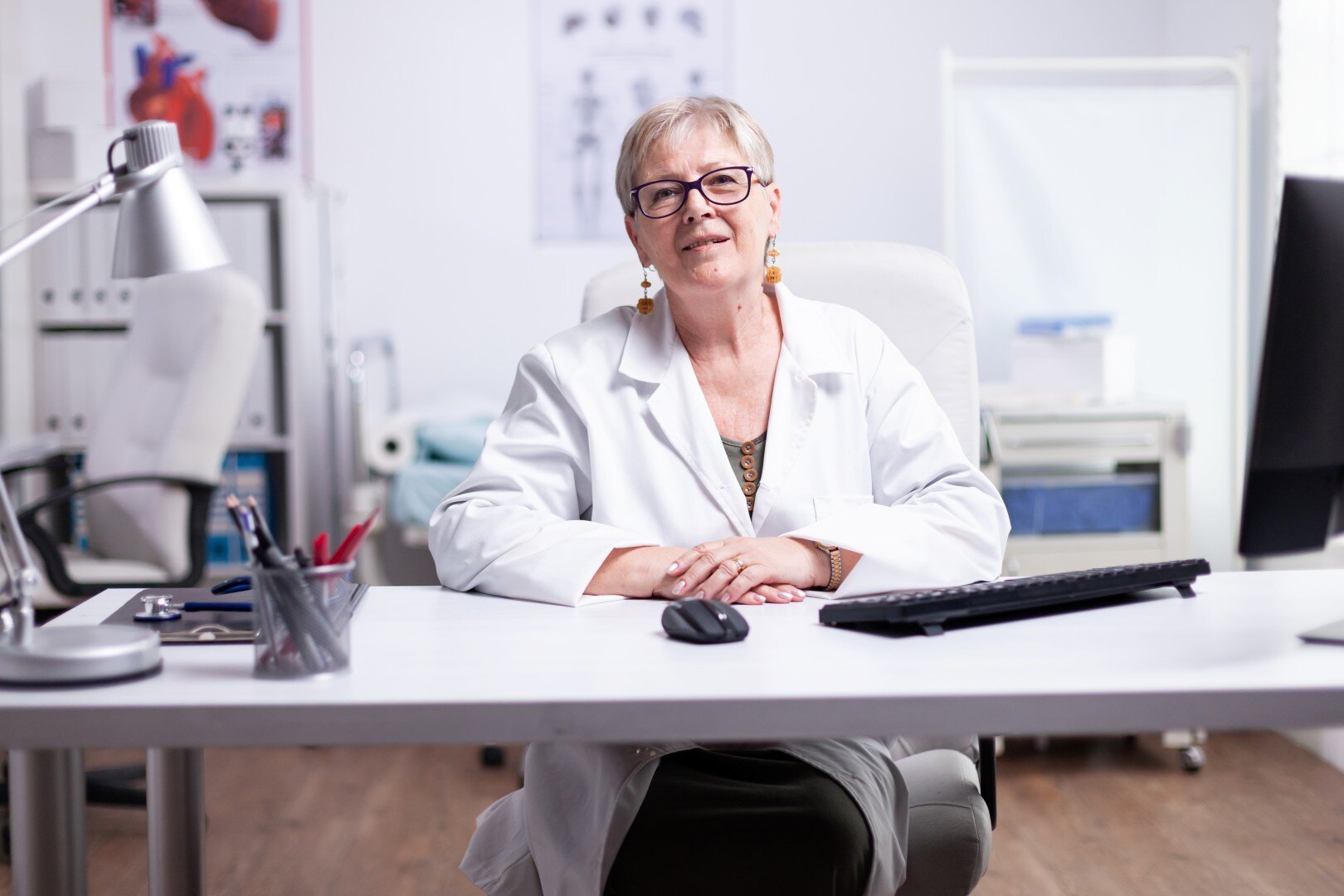 senior-medic-smiling-during-video-meeting-with-pat-2025-02-19-22-21-35-utc (Custom)